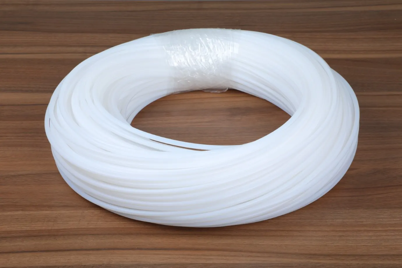 Coil of natural white PTFE tube